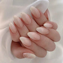 Hand with long, oval-shaped nails painted in a soft pink color against a light background, Obroi