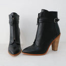Black ankle boots with wooden heel on a white background, branded 'Obroi'.