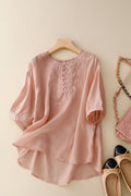 Pink blouse with lace details on a hanger, next to shoes and a handbag on a light background, Obroi