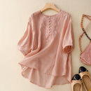 Pink blouse with lace details on a hanger, next to shoes and a handbag on a light background, Obroi