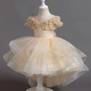 Beige flower girl dress on a mannequin against a dark background, Obroi