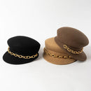 Three hats in black, brown, and beige with gold chains on a white background, Obroi