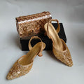 Gold glittery high-heeled shoes and a matching handbag on a white background, Obroi