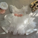 White baby dress with floral details on a neutral background, Obroi