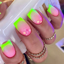 Nails with pink and green gradient design held by a hand wearing gold rings, Obroi