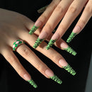 Obroi Hand with green and black patterned nails against a dark background