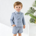 Child wearing a blue checkered suit with a bow tie on a white background, Obroi