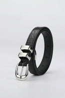 Black leather belt with silver buckle on a light gray background, Obroi