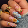Close-up of a hand with intricately designed nails featuring sea-themed decorations, Obroi