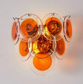 Modern ceiling light fixture with orange glass shades on a white background, Obroi