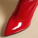 Shiny red high-heeled shoe on a beige background, Obroi