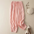 Pink pants with a white handbag and shoes on a beige background, Obroi