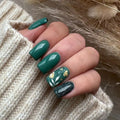 Obroi Close-up of a hand with green nail polish on a textured fabric background
