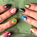 Colorful nail art on a green fabric background, Obroi