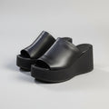 Black platform sandals on a light gray background, Obroi