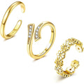 Set of gold rings with different designs on a white background, Obroi