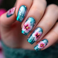 Nails with floral design in teal and pink on a blurred background, Obroi