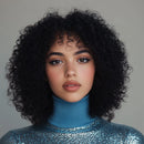 Woman with curly hair wearing a blue sequin top against a gray background, Obroi