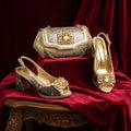 Gold and silver shoes and handbag on a red fabric background, Obroi
