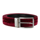 A burgundy velvet belt with a polished silver-tone buckle, coiled on a white background, Obroi