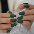 Close-up of hands with dark green nail polish holding a white lace fabric ,Obroi