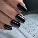 Close-up of a hand with black nail polish holding an open book, Obroi