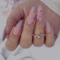 Close-up of a hand with pink and purple nail polish and a decorative ring, Obroi