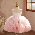 Pink floral dress on a mannequin against a neutral wall with a window, Obroi