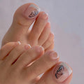 Close-up of hands with butterfly nail art on a light background, Obroi