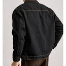 Black denim jacket worn by a person on a light gray background, Obroi