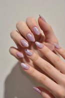 Close-up of hands with pink glittery nail polish on a light background, Obroi