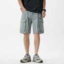 Person wearing gray cargo shorts on a white background, Obroi