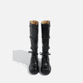 Pair of black knee-high boots on a white background, Obroi