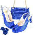 Blue high-heeled shoes with matching handbag and floral accessories on a white , Obroi