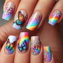 Colorful butterfly and rainbow-themed nail art on a hand, Obroi