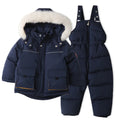 Navy blue winter jacket and bib overalls with white fur hood on a white background, Obroi