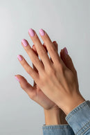 Close-up of hands with pink nail polish on a neutral background, Obroi