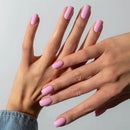 Close-up of hands with pink nail polish on a neutral background, Obroi