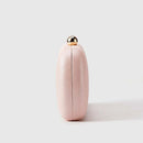 Pink clutch with a gold cap on a light gray background, Obroi