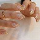 Close-up of hands with pink and gold glittery nail polish on a neutral background, Obroi