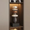 Stack of stones on a small pedestal in a dimly lit room, Obroi