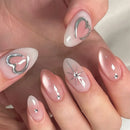 Nails with decorative designs and rhinestones on a neutral background, Obroi