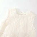 An off-white sleeveless lace top with floral embroidery and scalloped edges, shown against a plain white background, Obroi