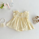 Yellow baby dress with ruffled collar on a light gray background, Obroi