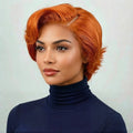 Woman with orange hair wearing a navy turtleneck against a light background, Obroi