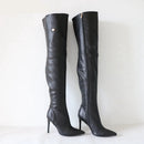 Black knee-high boots with high heels on a white background, branded 'Obroi'.