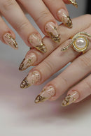 Nails with gold and beige design on a neutral background, Obroi