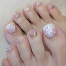 Obroi Close-up of toes with pink nail polish and decorative elements on a light background