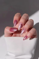 Hand with pink nail polish and gold rings on a neutral background, Obroi
