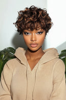 Woman with styled hair wearing a beige hoodie against a light background, Obroi